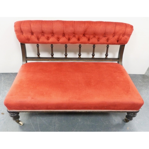 109 - Late Victorian aesthetic ebonised boudoir sofa, upholstered in later red button-back Dralon, with sp... 