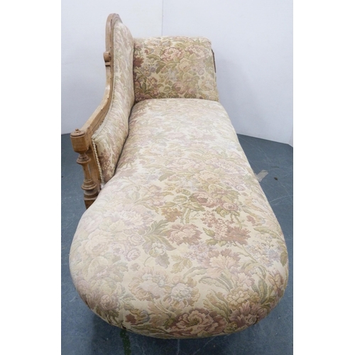 110 - Late Victorian walnut scroll-back chaise longue, upholstered in later floral fabric, carved with app... 