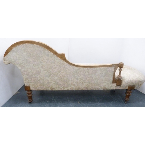 110 - Late Victorian walnut scroll-back chaise longue, upholstered in later floral fabric, carved with app... 