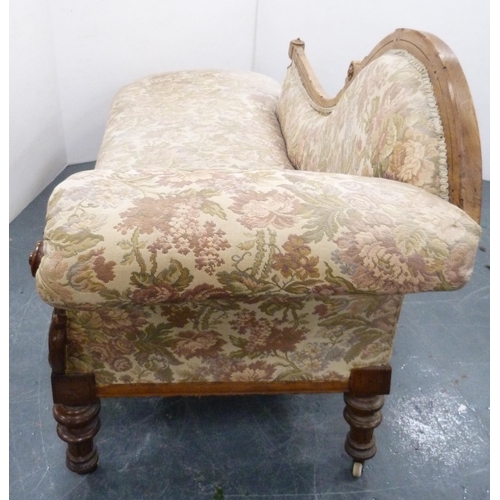 110 - Late Victorian walnut scroll-back chaise longue, upholstered in later floral fabric, carved with app... 