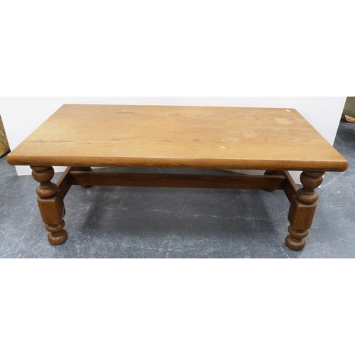 111 - Heavy oak coffee table with rectangular top on turned and block supports, 53cm high and 140cm wide.