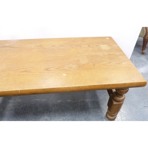 111 - Heavy oak coffee table with rectangular top on turned and block supports, 53cm high and 140cm wide.