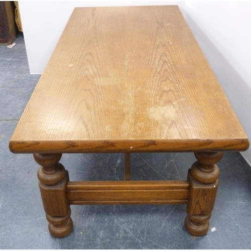 111 - Heavy oak coffee table with rectangular top on turned and block supports, 53cm high and 140cm wide.