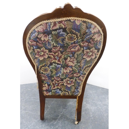 112 - Victorian walnut lady's spoon-back chair, upholstered in floral stuff-over fabric, on ceramic castor... 