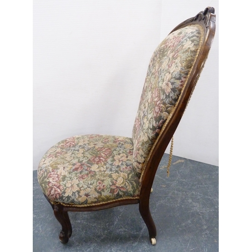 112 - Victorian walnut lady's spoon-back chair, upholstered in floral stuff-over fabric, on ceramic castor... 