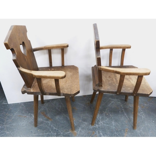 116 - Pair of Arts & Crafts-style rustic pine armchairs, possibly Continental, each with a stylised he... 