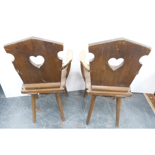 116 - Pair of Arts & Crafts-style rustic pine armchairs, possibly Continental, each with a stylised he... 