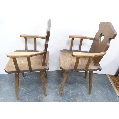 116 - Pair of Arts & Crafts-style rustic pine armchairs, possibly Continental, each with a stylised he... 