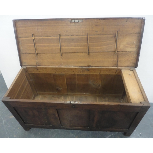 132 - 19th century oak coffer with hinged top enclosing a pine candle box, three-panel front, iron lock, o... 