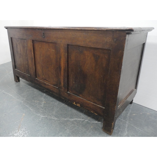 132 - 19th century oak coffer with hinged top enclosing a pine candle box, three-panel front, iron lock, o... 