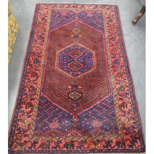 133 - North West Persian hand-knotted rug with geometric medallion to the centre within further geometric ... 