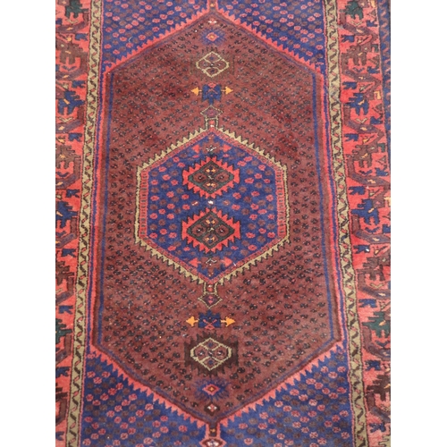 133 - North West Persian hand-knotted rug with geometric medallion to the centre within further geometric ... 