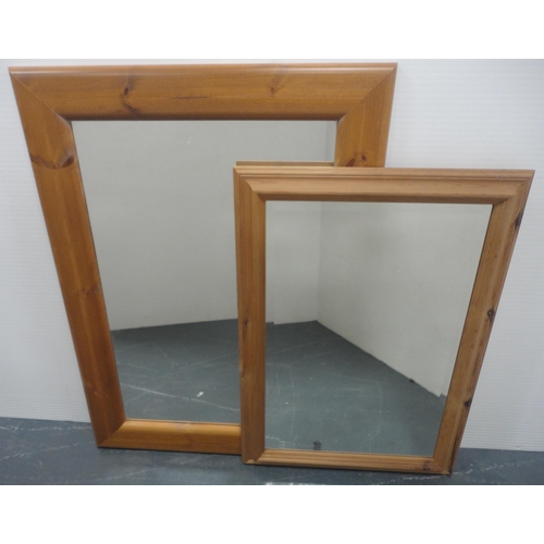 64 - Two modern pine-framed wall mirrors, the largest 96cm x 69cm.  (2)