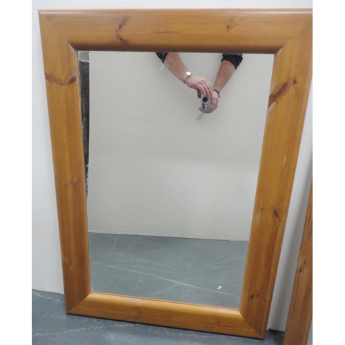 64 - Two modern pine-framed wall mirrors, the largest 96cm x 69cm.  (2)