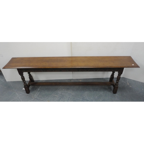 145 - Victorian-style oak bench with plank top, incised decoration to the frieze, on turned columns and bl... 