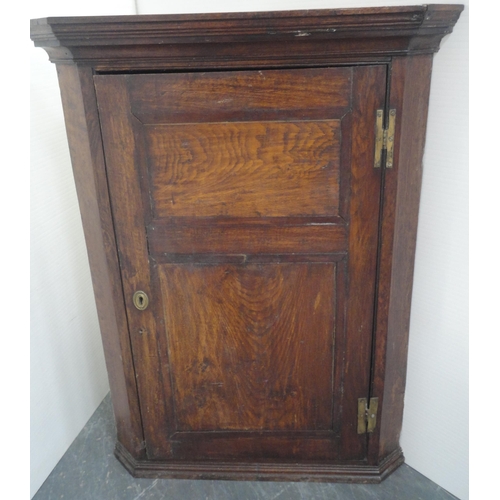 156 - Late 18th century oak corner cupboard with panelled door enclosing shelving, 108cm high, 82cm wide a... 