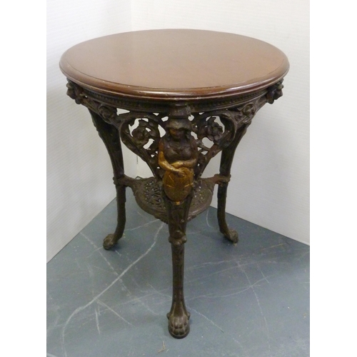 174 - Cast iron painted pub table, with circular wooden top, the supports decorated with Britannia within ... 