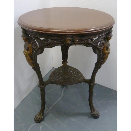 174 - Cast iron painted pub table, with circular wooden top, the supports decorated with Britannia within ... 