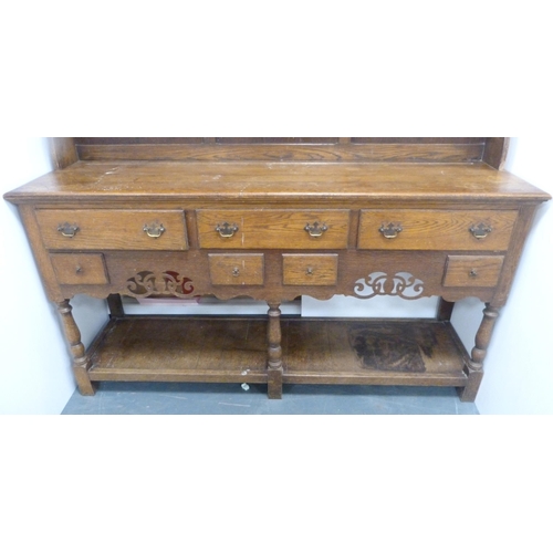 184 - Late 19th/early 20th century oak dresser with shaped apron to the top above two open shelves, the ba... 