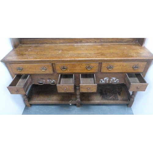 184 - Late 19th/early 20th century oak dresser with shaped apron to the top above two open shelves, the ba... 