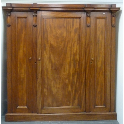 186 - Victorian mahogany three-door wardrobe with shaped cornice above large central door enclosing fitted... 