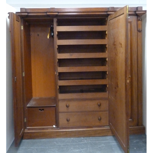 186 - Victorian mahogany three-door wardrobe with shaped cornice above large central door enclosing fitted... 