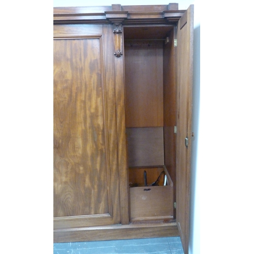 186 - Victorian mahogany three-door wardrobe with shaped cornice above large central door enclosing fitted... 