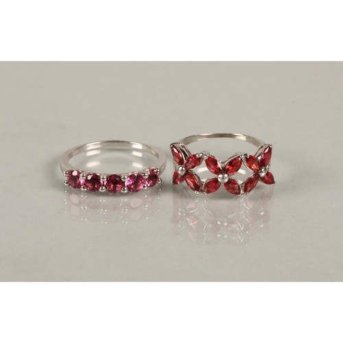 148 - 9ct white gold ring set with five garnets, ring size S, 2.8g, and a 9k white gold ring set with red ... 