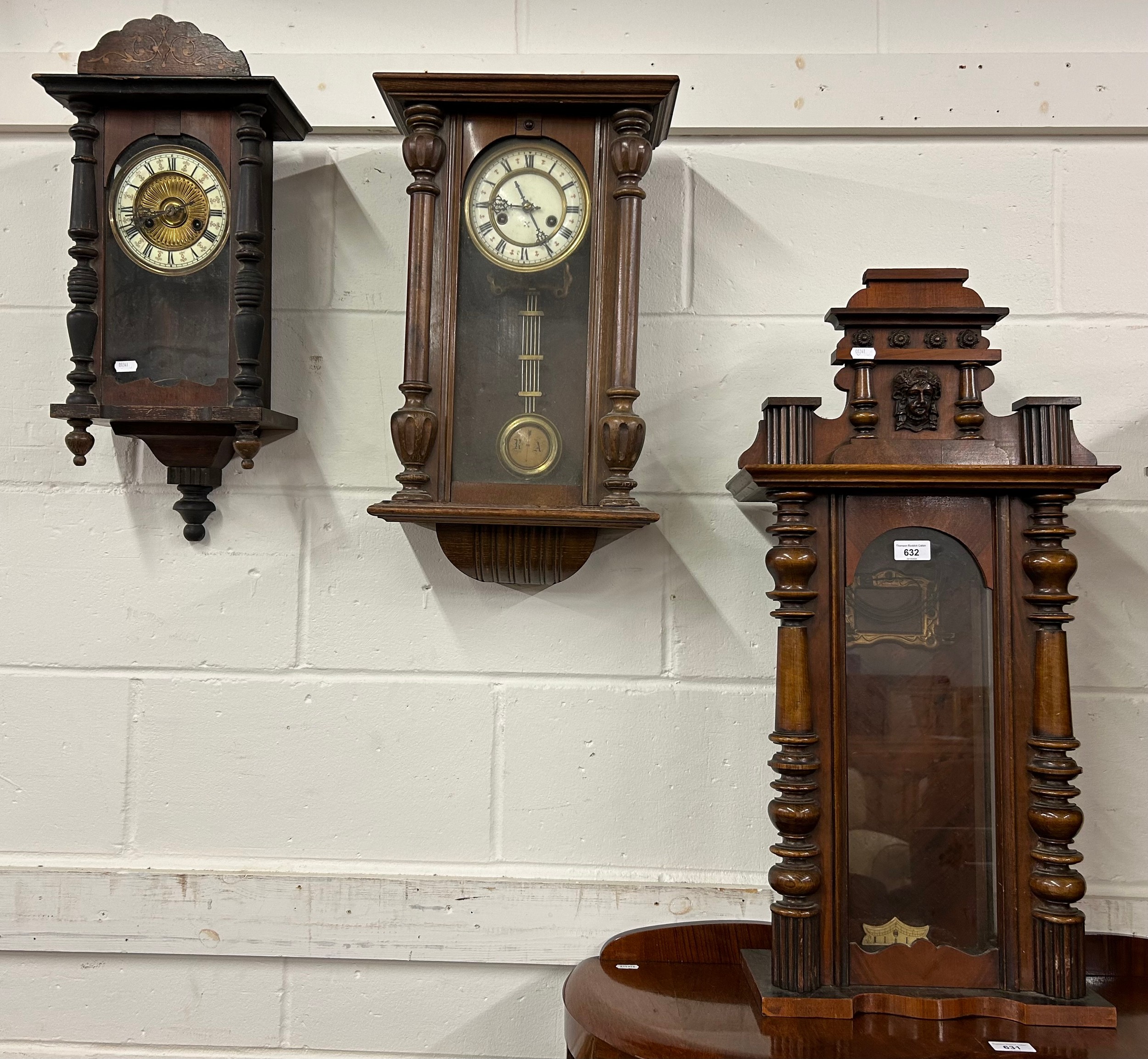 Three assorted cased wall clocks.