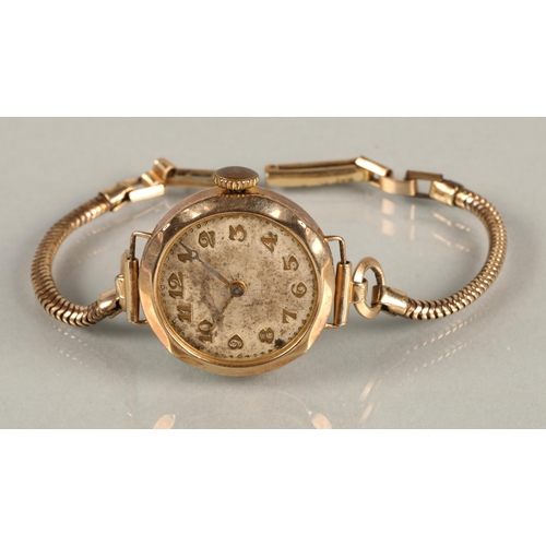 117 - 9ct gold ladies wristwatch on rolled gold strap