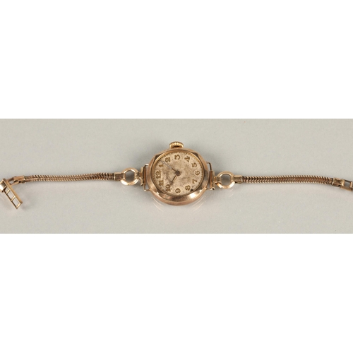 117 - 9ct gold ladies wristwatch on rolled gold strap