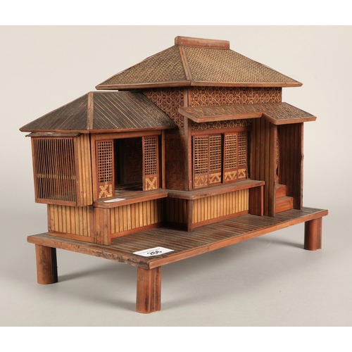 266 - Woven bamboo model of a Japanese house with sliding doors. 35cm wide