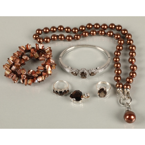 92 - Two silver rings, a silver pendant, and white metal bangle set with brown gems likely smoky quartz, ... 