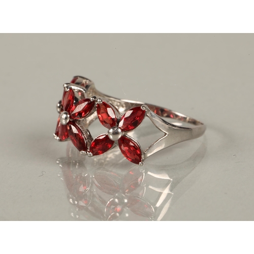 148 - 9ct white gold ring set with five garnets, ring size S, 2.8g, and a 9k white gold ring set with red ... 