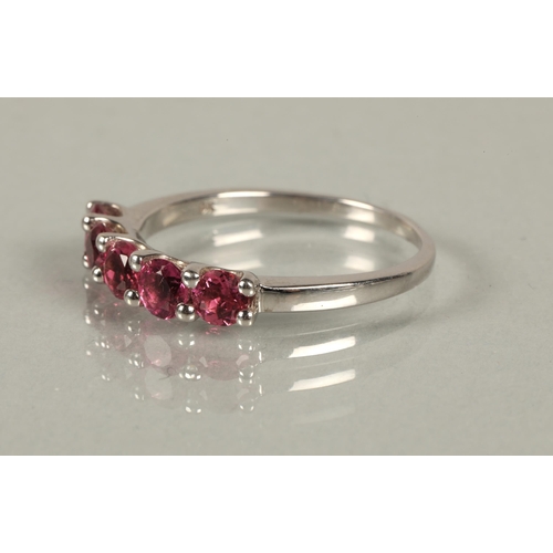 148 - 9ct white gold ring set with five garnets, ring size S, 2.8g, and a 9k white gold ring set with red ... 