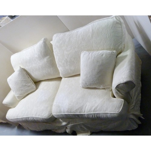 194 - Suite of three two-seater cream upholstered sofas.