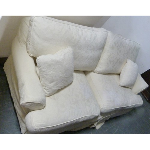 194 - Suite of three two-seater cream upholstered sofas.