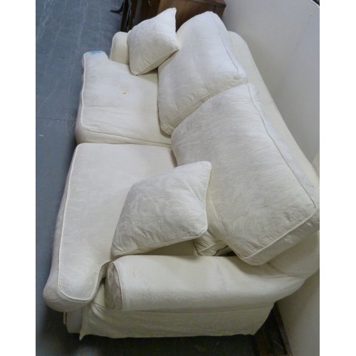 194 - Suite of three two-seater cream upholstered sofas.