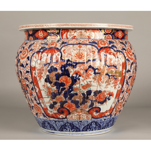 31 - Japanese Imari pattern jardinière of ribbed form, 37cm high.