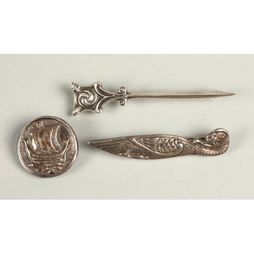 96 - Three assorted Alexander Ritchie Designed silver brooches, Norse boat, Zooamorphic bird and Celtic k... 