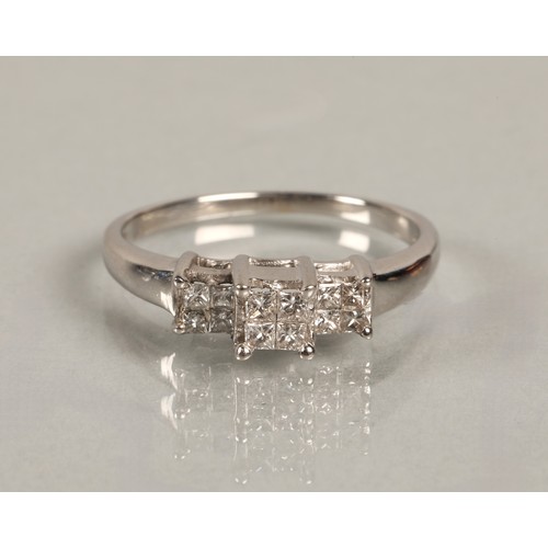 82 - Ladies diamond ring set in three groups of square cut diamonds, set on white metal shank, ring size ... 