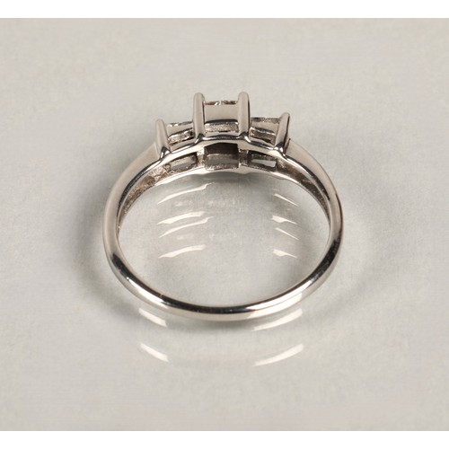 82 - Ladies diamond ring set in three groups of square cut diamonds, set on white metal shank, ring size ... 