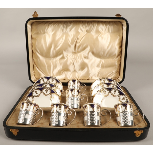 173 - Aynsley cased set of coffee cups and saucers with silver cup holders, assay marked Sheffield 1925, W... 