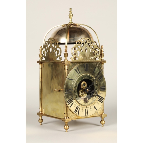 175 - Eureka electric lantern clock, the brass chapter ring enclosing a glazed centre with foliate engrave... 