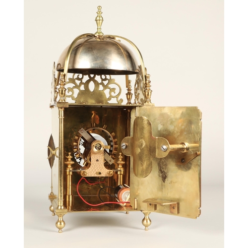 175 - Eureka electric lantern clock, the brass chapter ring enclosing a glazed centre with foliate engrave... 