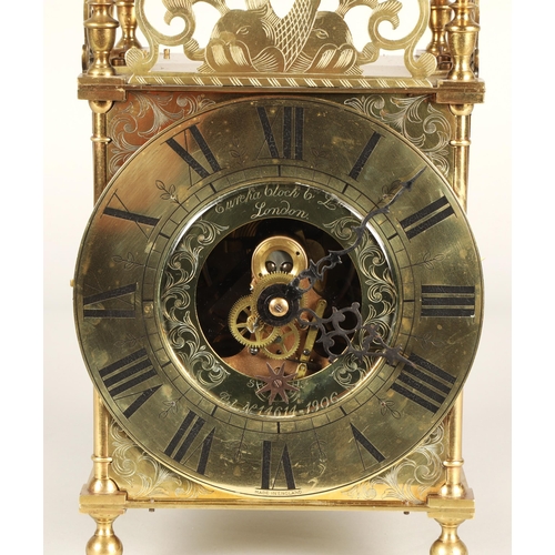 175 - Eureka electric lantern clock, the brass chapter ring enclosing a glazed centre with foliate engrave... 