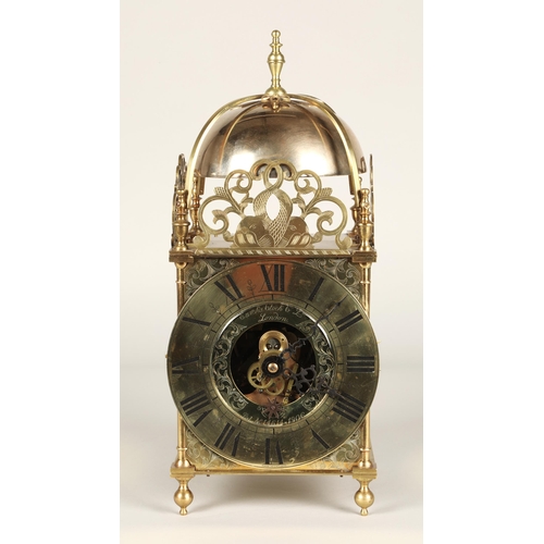 175 - Eureka electric lantern clock, the brass chapter ring enclosing a glazed centre with foliate engrave... 