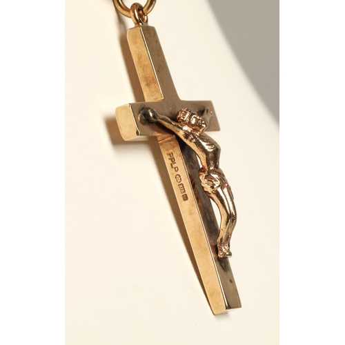 56 - 9ct yellow gold cross pendant on a 9ct yellow gold chain. total weight 16.8g.