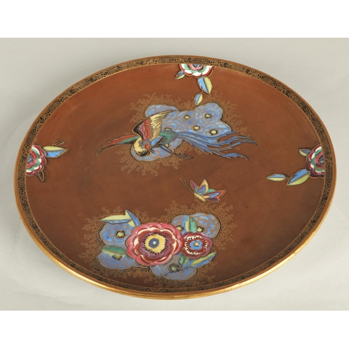 16 - Carlton ware charger in the New Chinese Bird & Cloud pattern, dark brown ground decorated with s... 