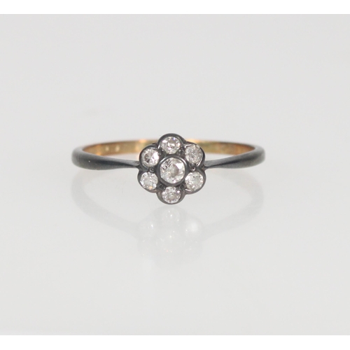 554 - Gold and diamond daisy cluster ring, gold hallmark rubbed, size U, 2.0g.